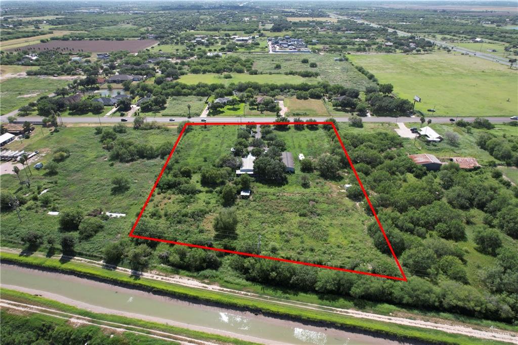 11204 North Ware Road McAllen, TX 78504 - Photo 3 of 5 an aerial view of green landscape with trees houses and mountain view