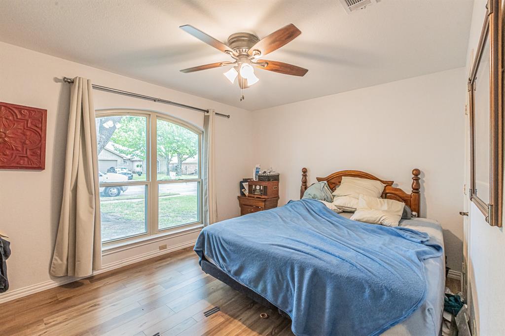 3309 Timber View Circle Bedford, TX 76021 - Photo 18 of 38 a bedroom with a large bed and a large window