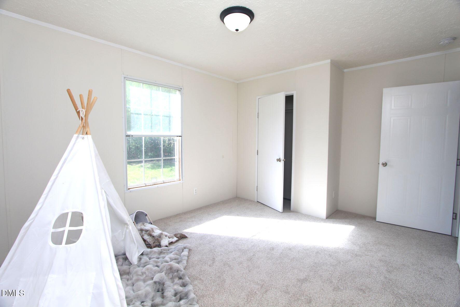 721 General Green Road Kittrell, NC 27544 - Photo 24 of 36 an empty room with windows
