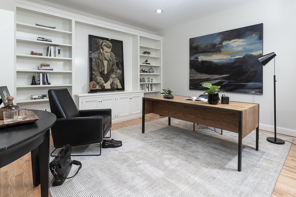 51 Rawson Road, Unit 51 Brookline, MA 02445 - Photo 12 of 23 a work room with furniture and a flat screen tv