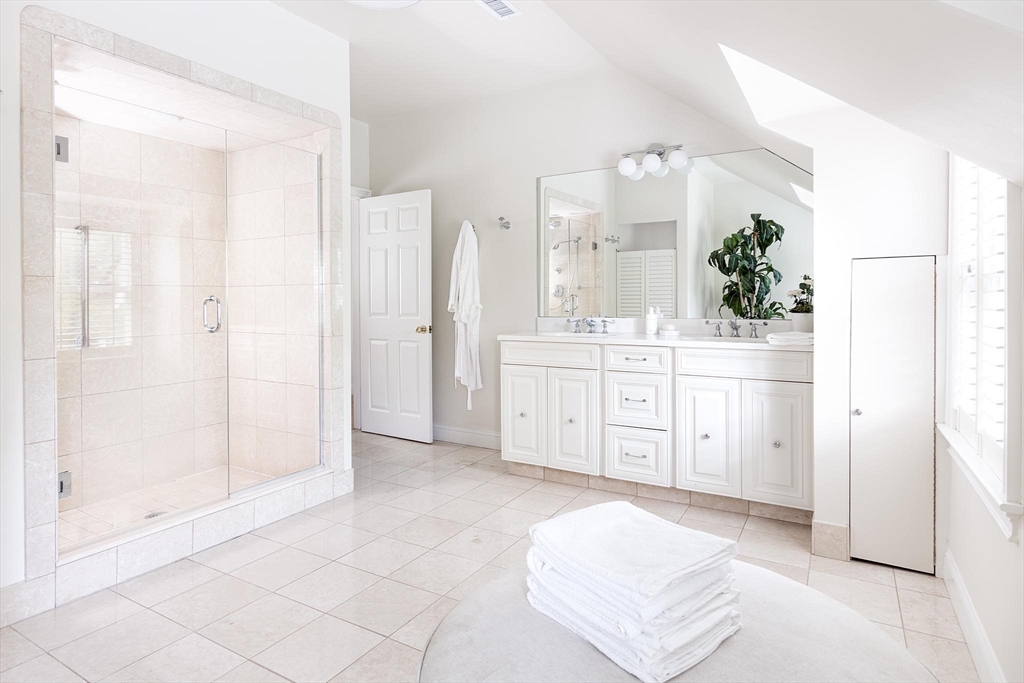 51 Rawson Road, Unit 51 Brookline, MA 02445 - Photo 15 of 23 a spacious bathroom with a double vanity sink a mirror and a shower
