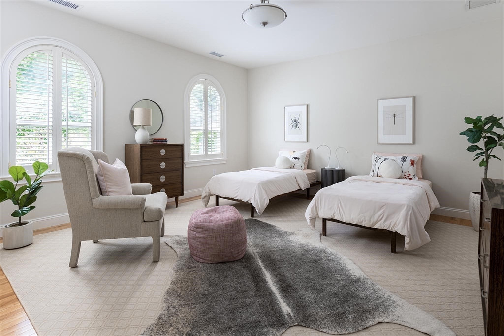 51 Rawson Road, Unit 51 Brookline, MA 02445 - Photo 19 of 23 a spacious bedroom with two beds and potted plant