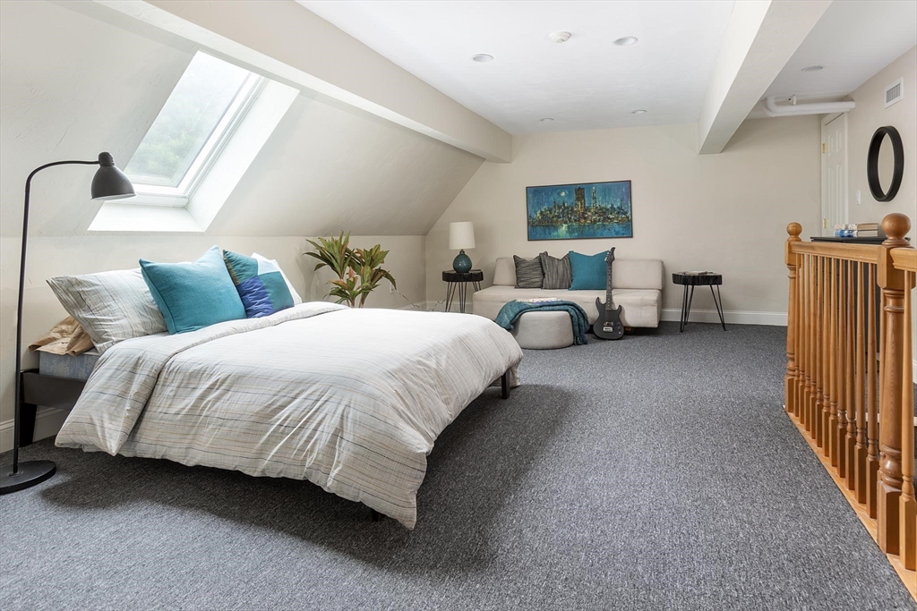 51 Rawson Road, Unit 51 Brookline, MA 02445 - Photo 20 of 23 a spacious bedroom with a bed and a couch