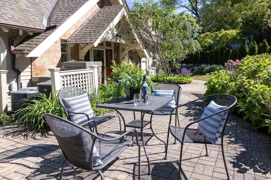 51 Rawson Road, Unit 51 Brookline, MA 02445 - Photo 21 of 23 a view of a patio with table and chairs and potted plants