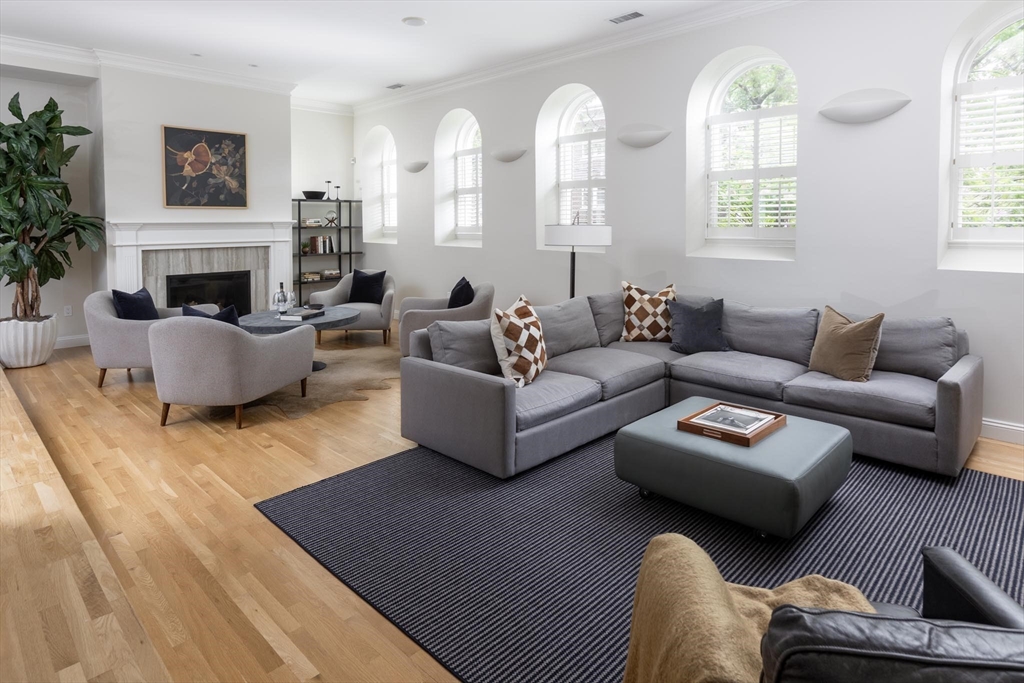 51 Rawson Road, Unit 51 Brookline, MA 02445 - Photo 5 of 23 a living room with furniture fireplace and a large window