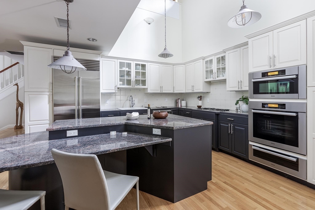 51 Rawson Road, Unit 51 Brookline, MA 02445 - Photo 9 of 23 a kitchen with granite countertop a sink a counter space appliances and cabinets