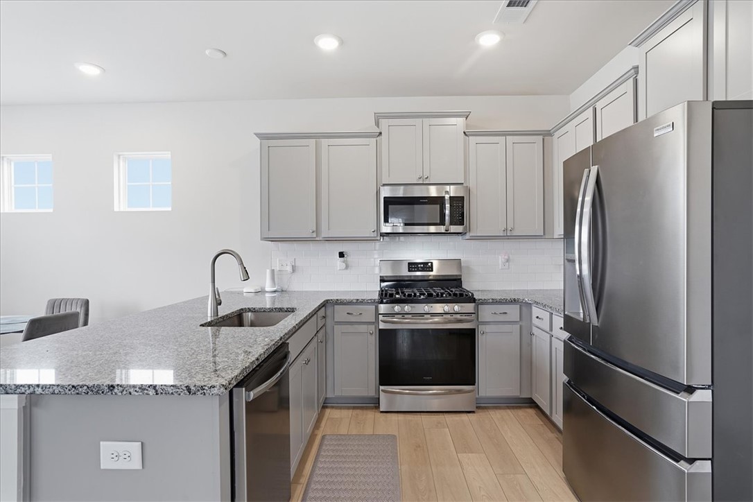 365 Sliding Rock Drive Pendleton, SC 29670 - Photo 12 of 46 Culinary delights await in this modern kitchen featuring granite countertops and stainless steel appliances.