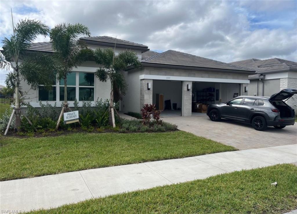 12181 Eucalyptus Way Naples, FL 34120 - Photo 1 of 13 a view of a house with a yard and plants