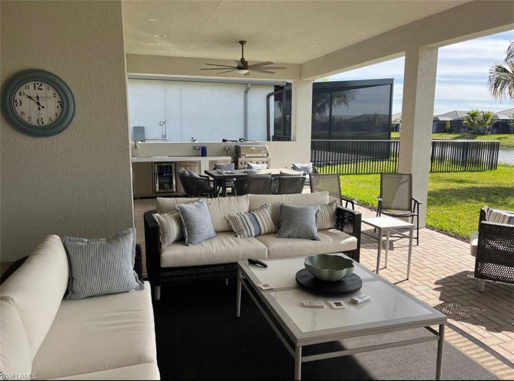 12181 Eucalyptus Way Naples, FL 34120 - Photo 12 of 13 a living room with furniture and a large window