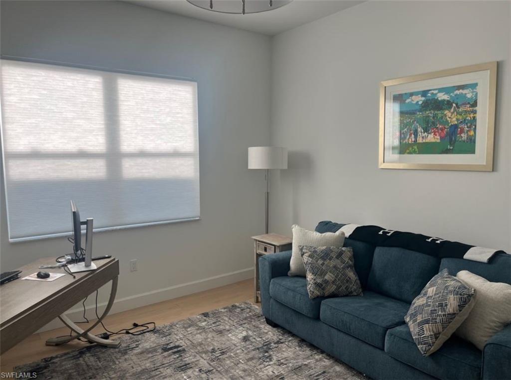 12181 Eucalyptus Way Naples, FL 34120 - Photo 6 of 13 a living room with furniture and a window
