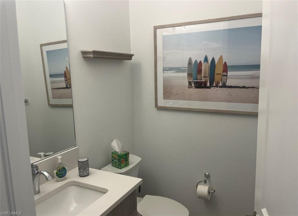 12181 Eucalyptus Way Naples, FL 34120 - Photo 7 of 13 a bathroom with a sink and a mirror