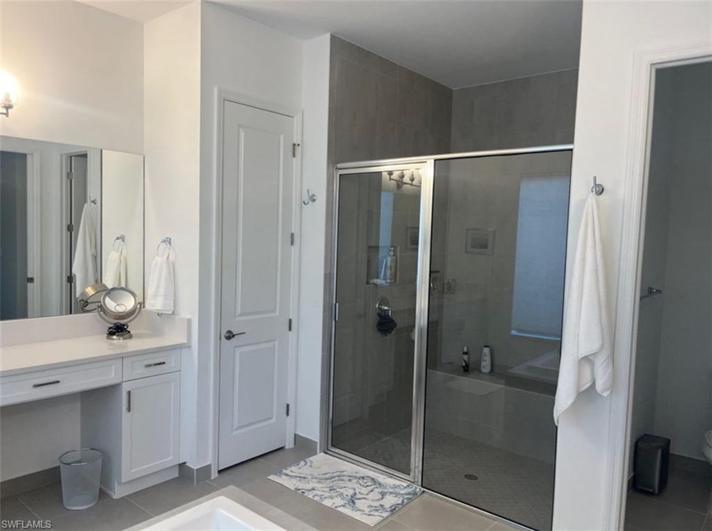 12181 Eucalyptus Way Naples, FL 34120 - Photo 9 of 13 a bathroom with a shower and a sink