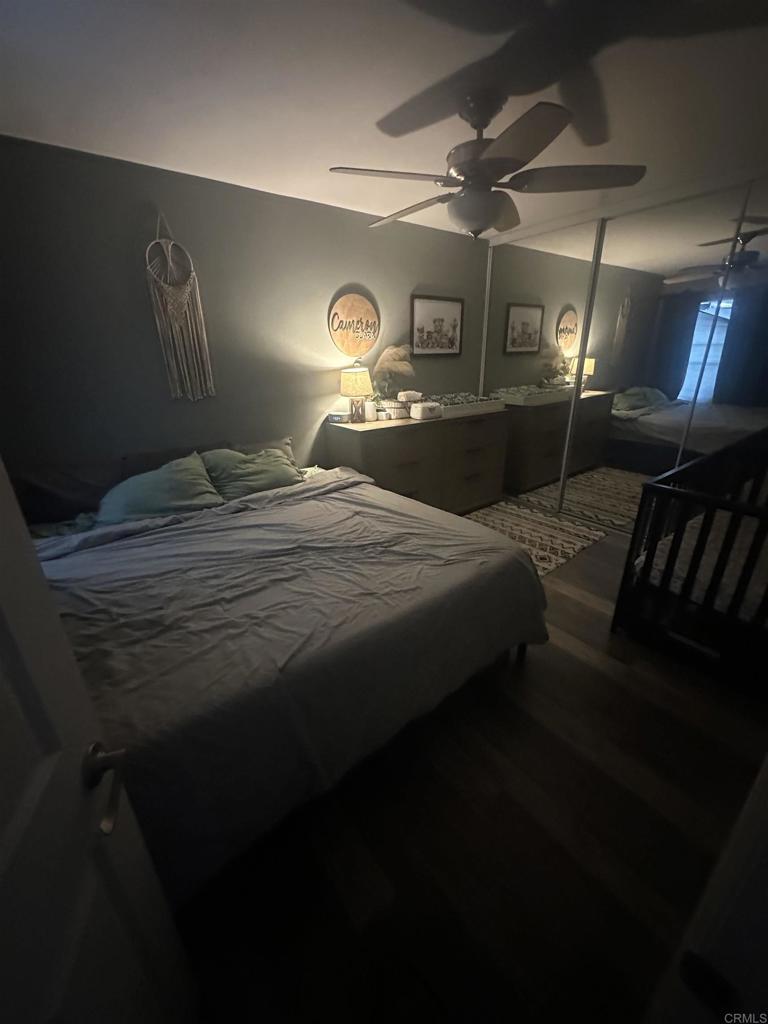 1401 Reed Avenue, Unit 3 San Diego, CA 92109 - Photo 15 of 16 a bedroom with a bed and a mirror on the dresser