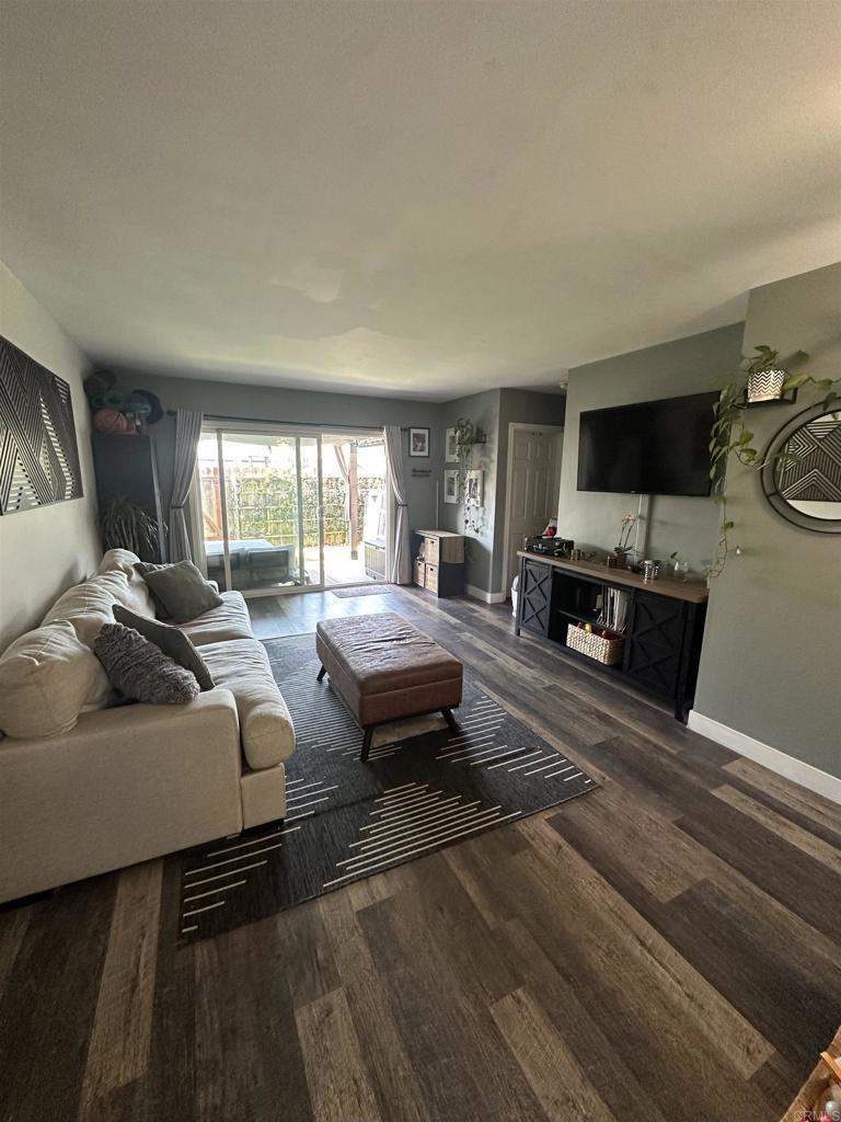 1401 Reed Avenue, Unit 3 San Diego, CA 92109 - Photo 4 of 16 a living room with furniture and a flat screen tv