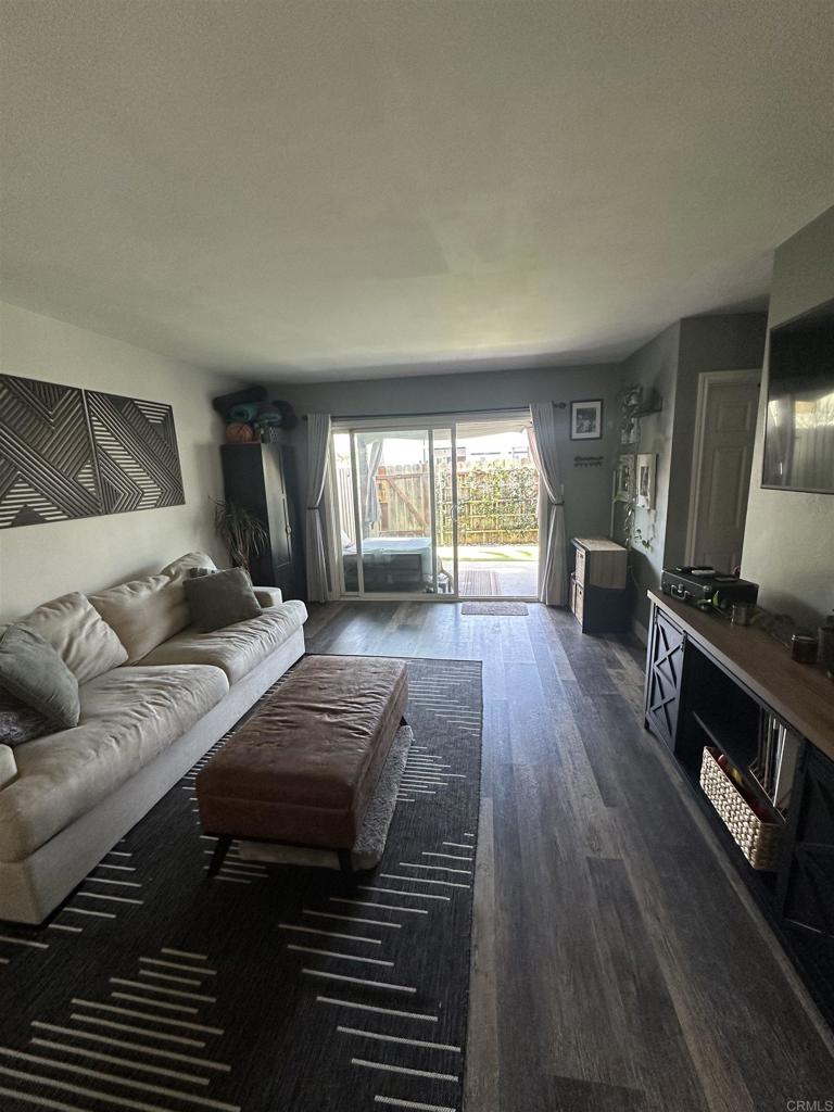 1401 Reed Avenue, Unit 3 San Diego, CA 92109 - Photo 5 of 16 a living room with furniture and a flat screen tv