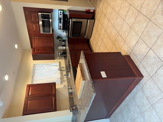 120 East 6th Road Queens, NY 11693 - Photo 4 of 22 a kitchen with stainless steel appliances granite countertop a stove a sink and a microwave