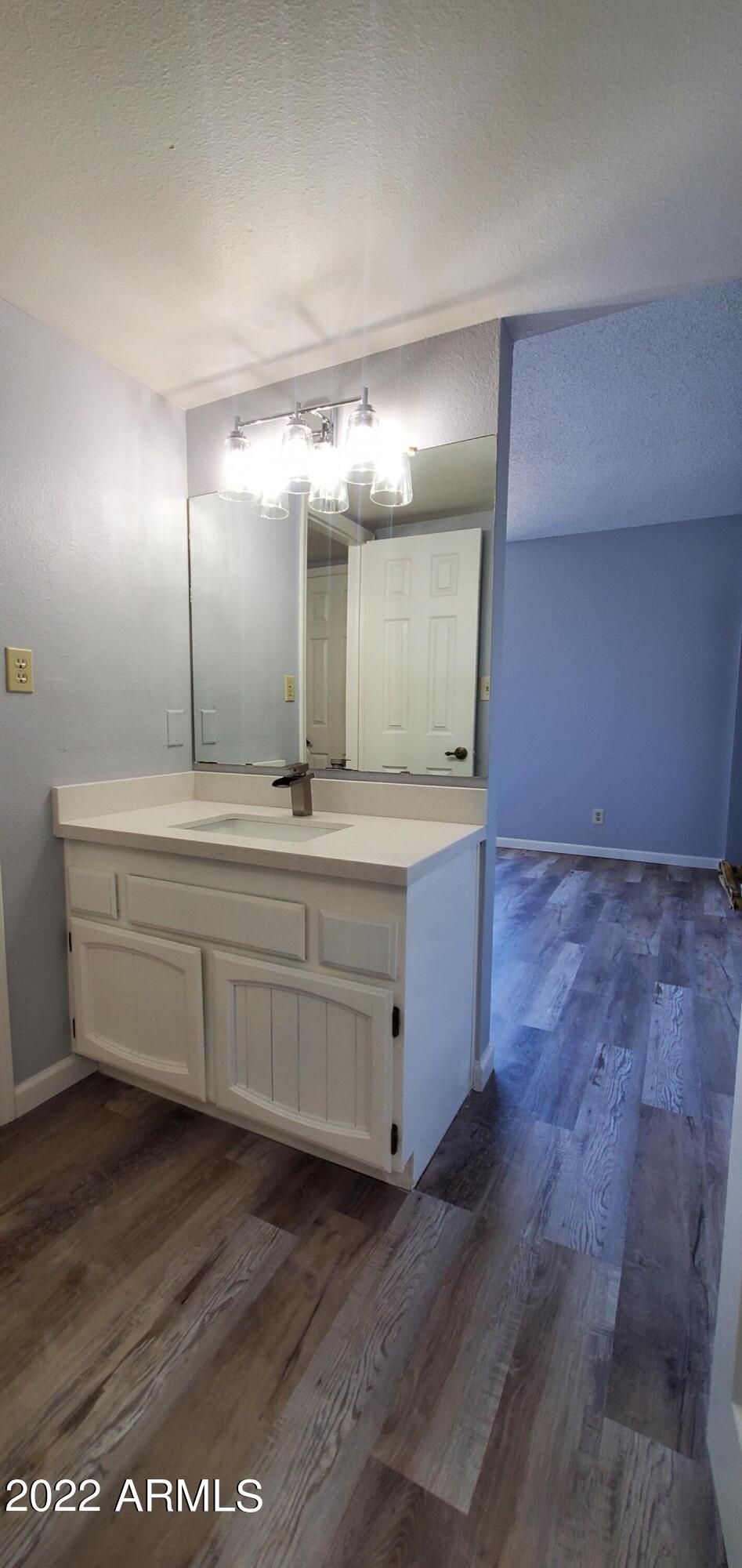 3411 North 12th Place, Unit 8 Phoenix, AZ 85014 - Photo 13 of 41 a bathroom with a double vanity sink and a mirror