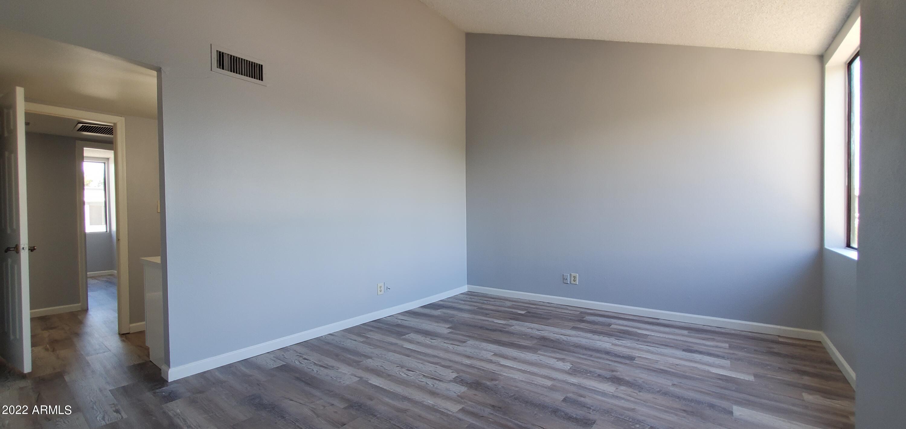3411 North 12th Place, Unit 8 Phoenix, AZ 85014 - Photo 16 of 41 a view of room with wooden floor