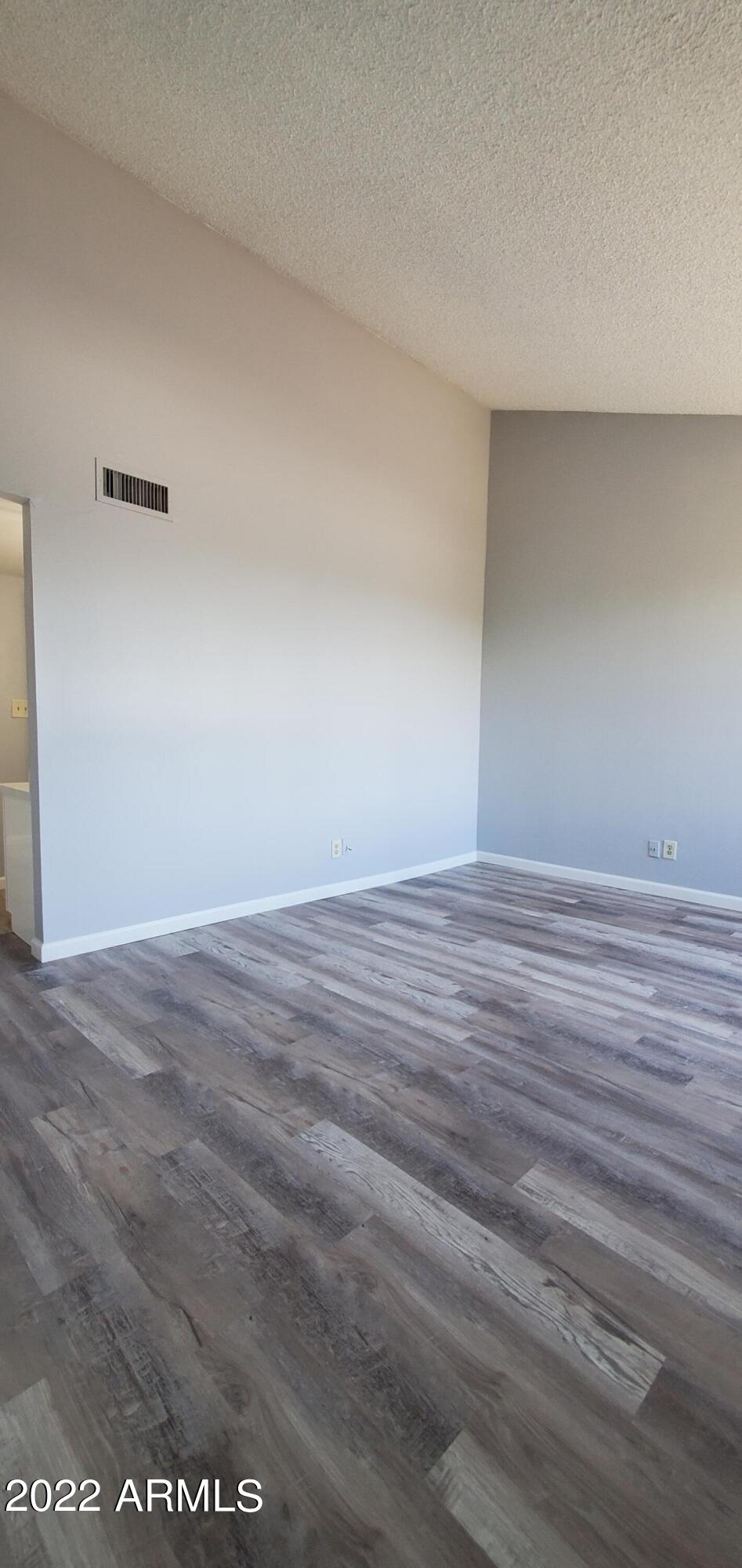 3411 North 12th Place, Unit 8 Phoenix, AZ 85014 - Photo 17 of 41 a view of an empty room with wooden floor