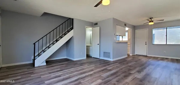a view of entryway and hall with wooden floor