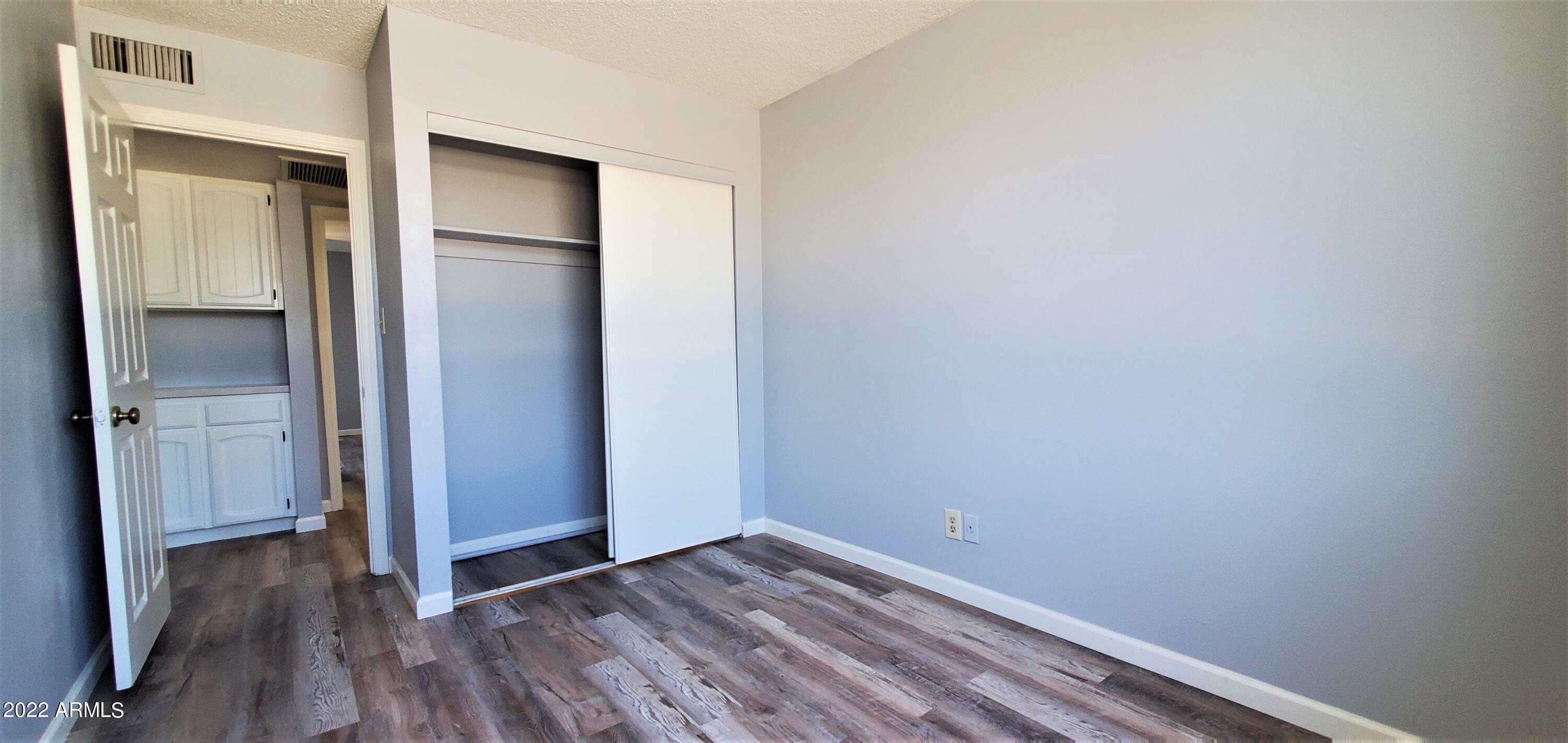 3411 North 12th Place, Unit 8 Phoenix, AZ 85014 - Photo 33 of 41 a view of empty room with wooden floor