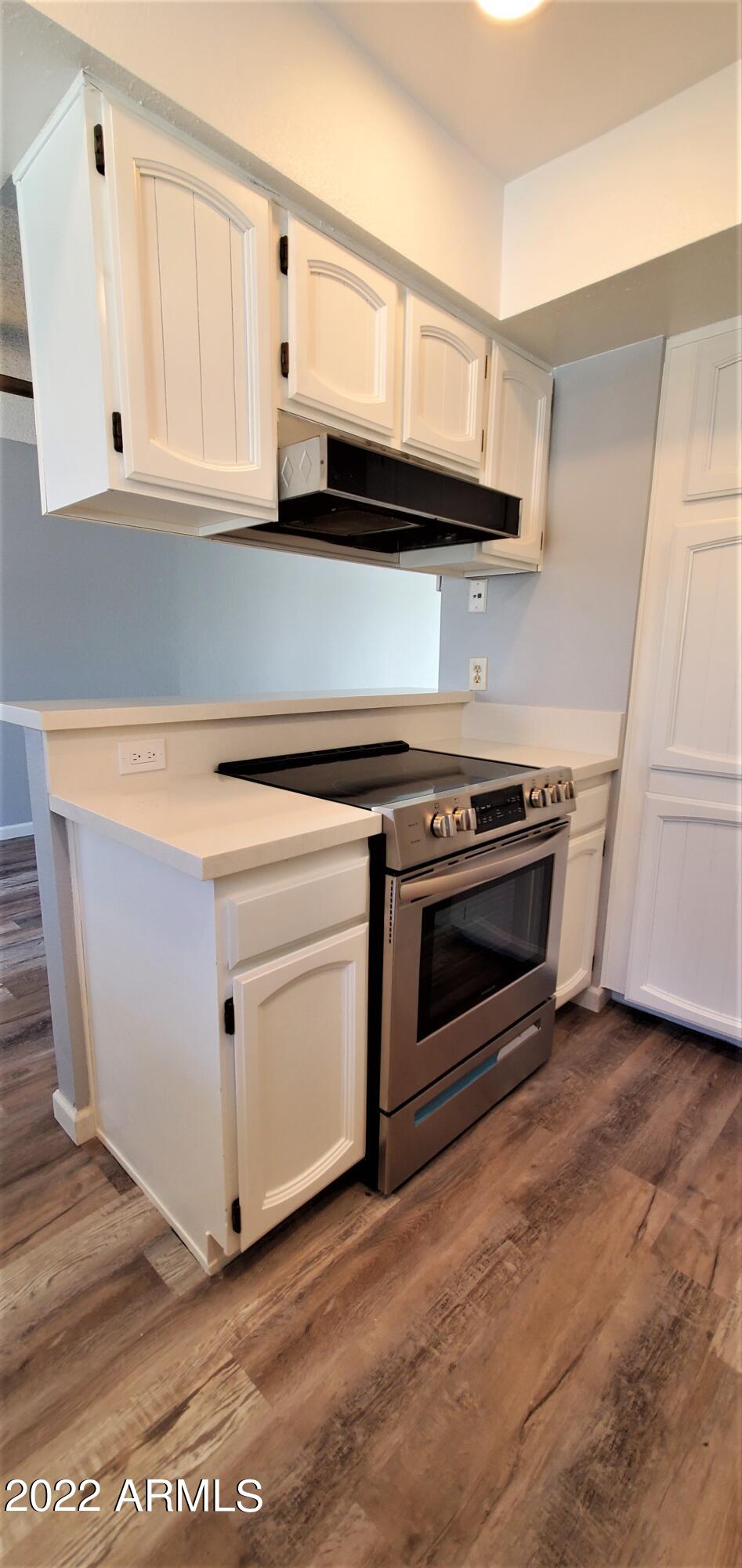 3411 North 12th Place, Unit 8 Phoenix, AZ 85014 - Photo 4 of 41 a kitchen with white cabinets and white appliances