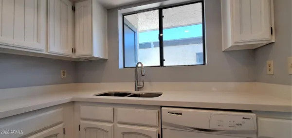 a kitchen with appliances cabinets and a sink