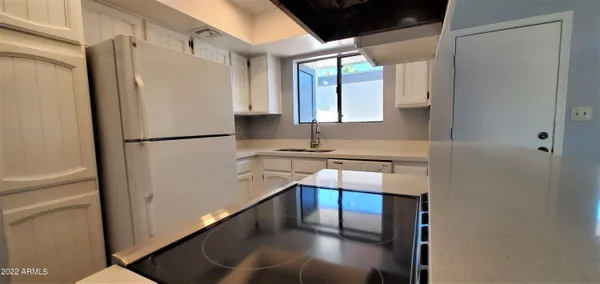a white refrigerator freezer sitting in a kitchen