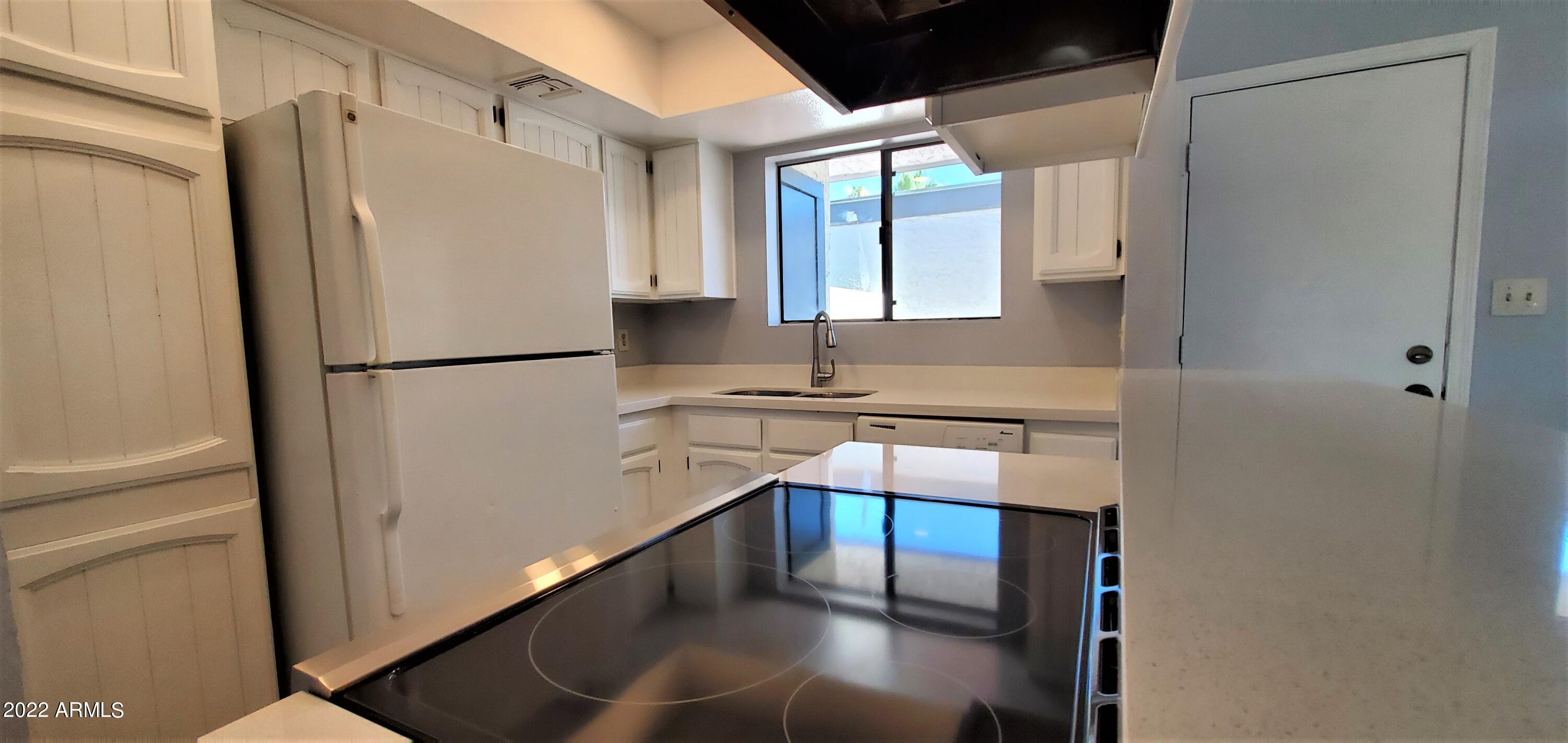 3411 North 12th Place, Unit 8 Phoenix, AZ 85014 - Photo 7 of 41 a white refrigerator freezer sitting in a kitchen