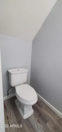 a white toilet sitting next to a shower