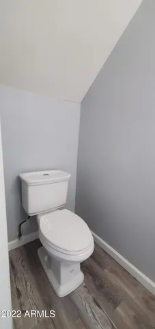 a white toilet sitting next to a shower