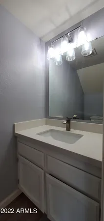 a bathroom with a sink vanity and mirror