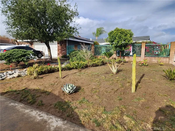 a view of a backyard with plants and a patio