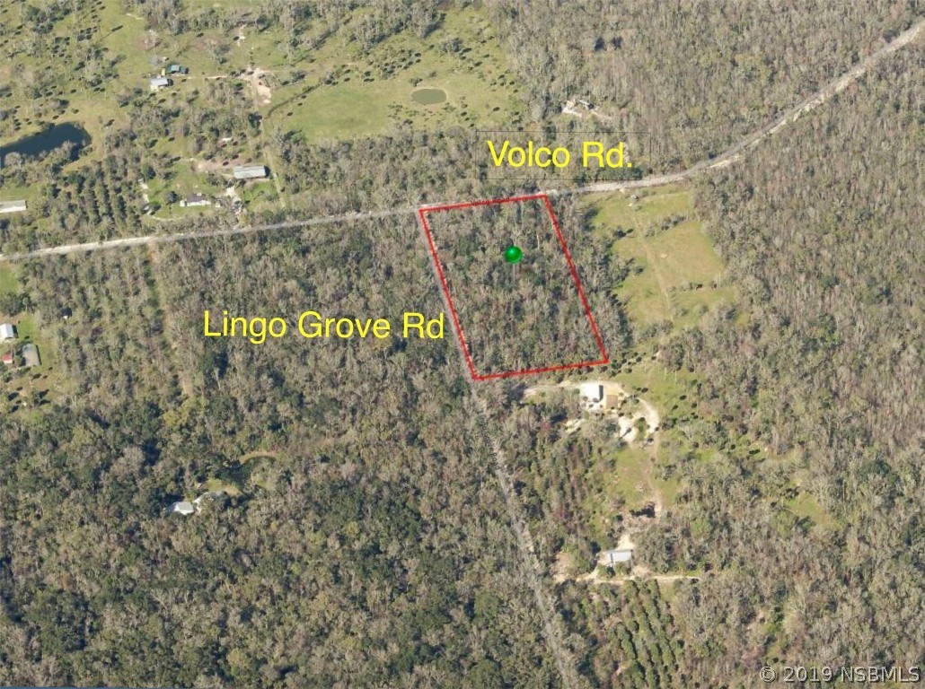 a view of sign board with buildings in background