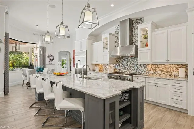 a kitchen with sink cabinets and dining table chairs
