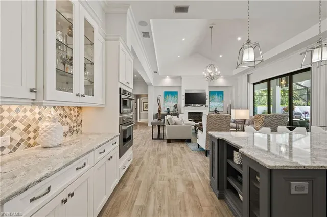 a large kitchen with stainless steel appliances kitchen island granite countertop a large center island attached withe living room