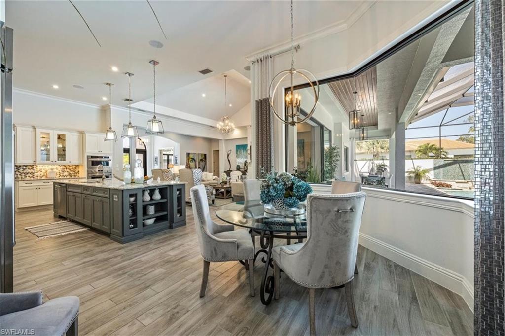 6363 Burnham Road Naples, FL 34119 - Photo 15 of 38 a view of a dining room with furniture window and wooden floor