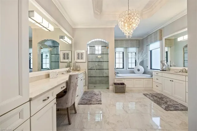 a large white kitchen with a lot of counter space and cabinets