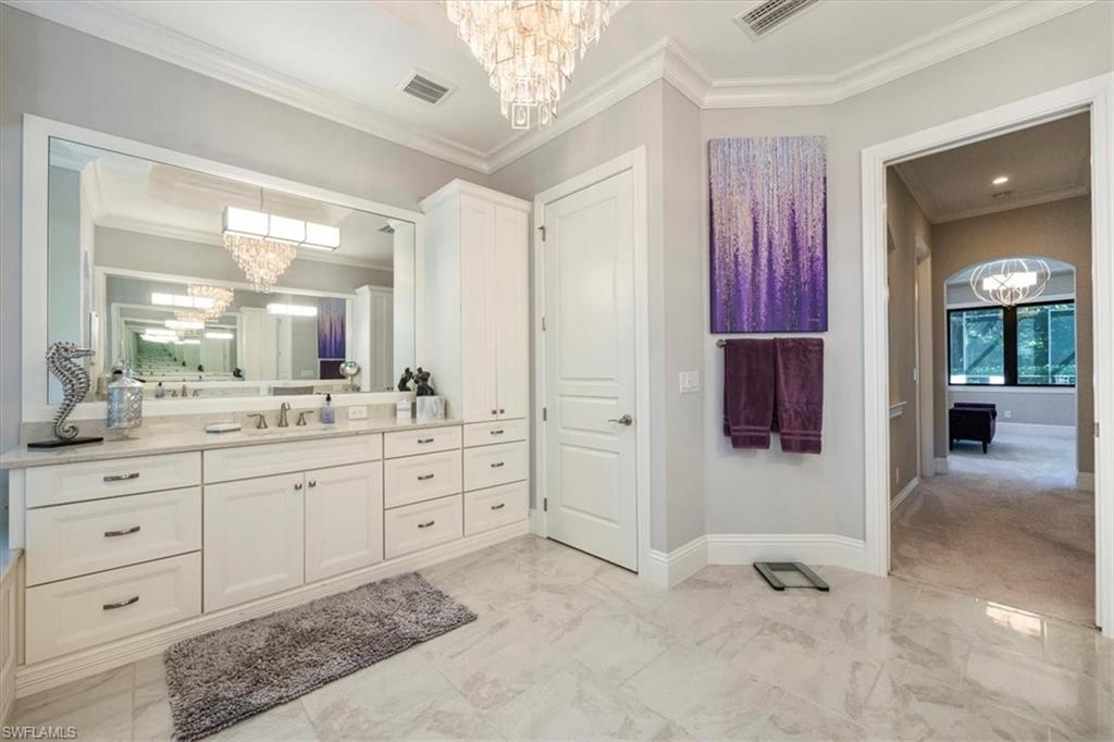 6363 Burnham Road Naples, FL 34119 - Photo 20 of 38 a spacious bathroom with a shower sink and mirror