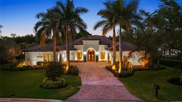 a house with palm tree in front of it