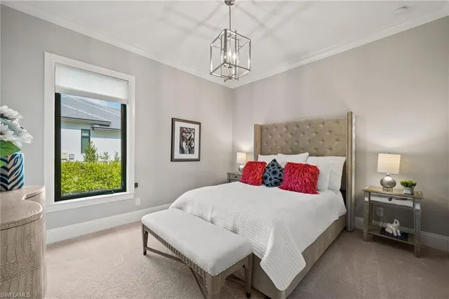 a bedroom with a bed and a chandelier