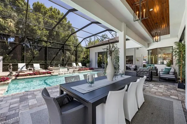 a view of a patio with table and chairs and potted plants