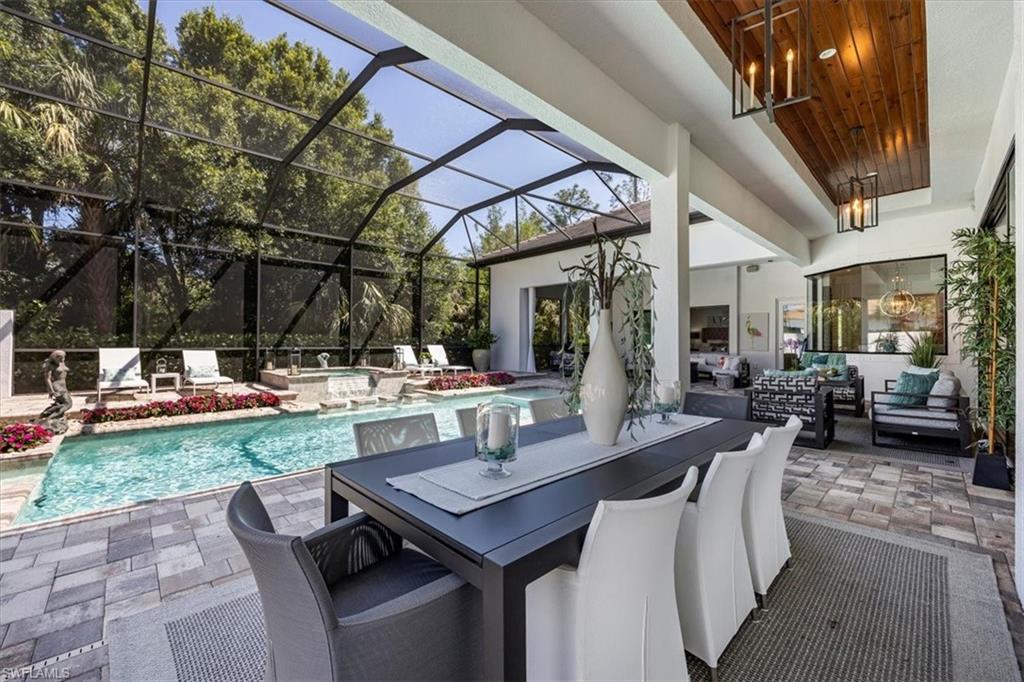 6363 Burnham Road Naples, FL 34119 - Photo 27 of 38 a view of a patio with table and chairs and potted plants