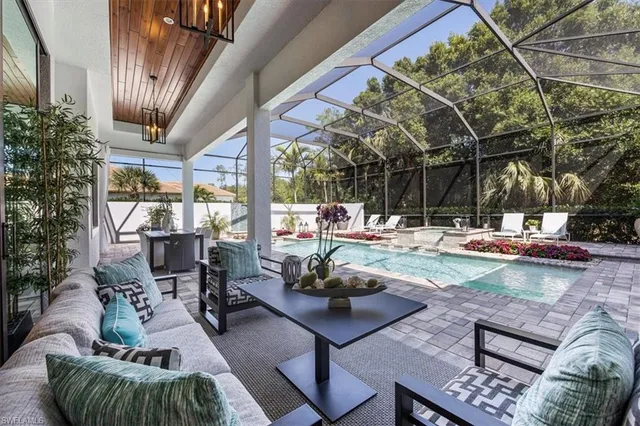 a living room with patio furniture and a fountain