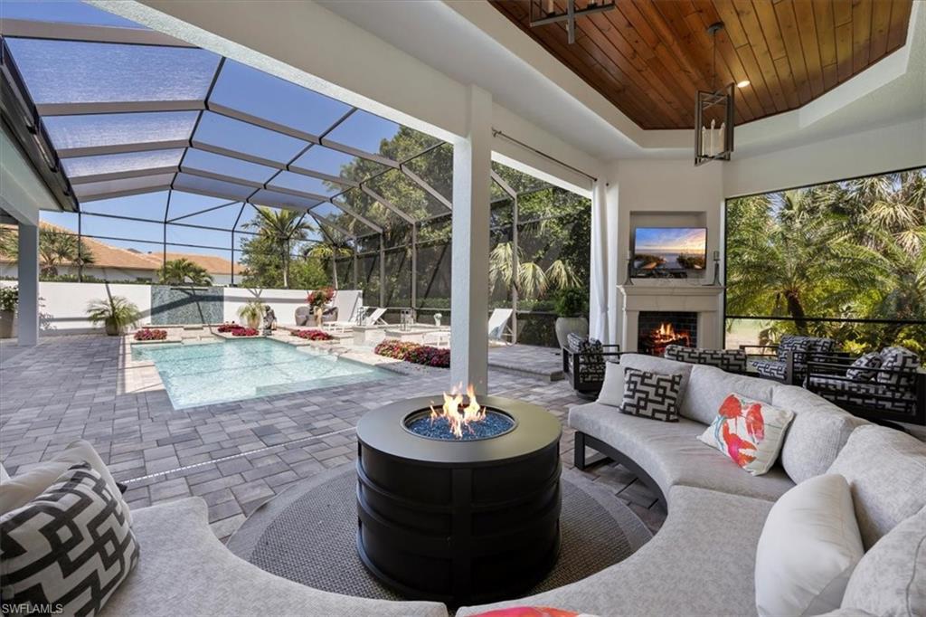 6363 Burnham Road Naples, FL 34119 - Photo 30 of 38 a living room with patio fireplace furniture and a potted plant