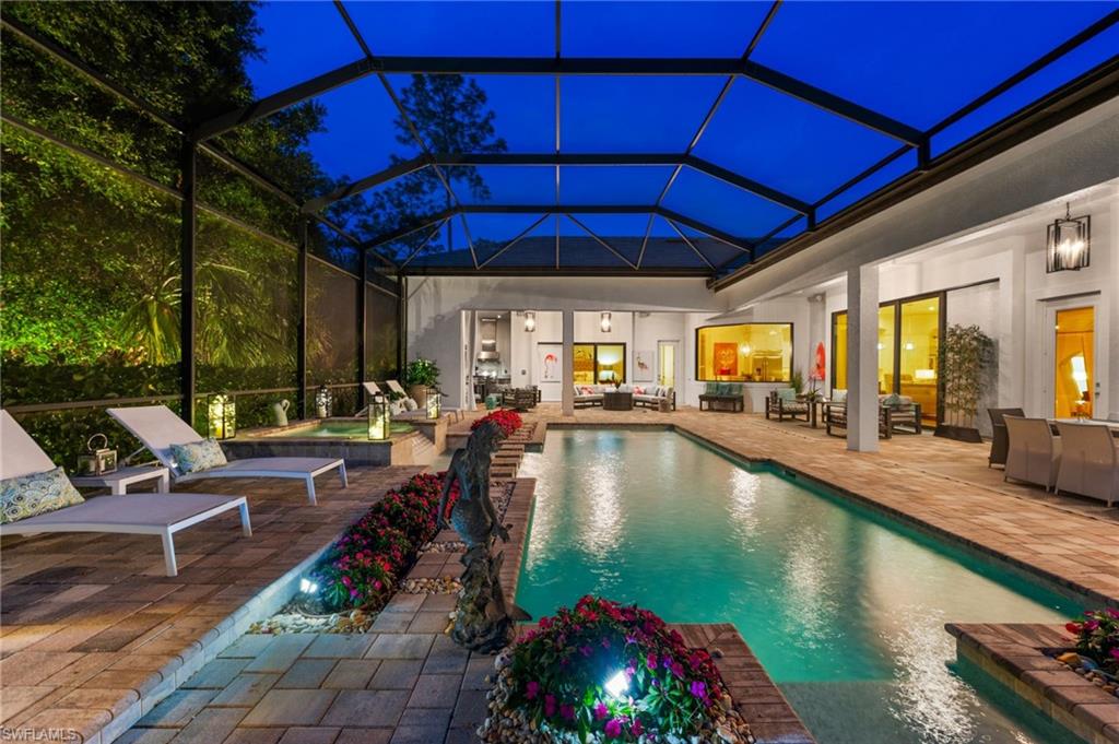 6363 Burnham Road Naples, FL 34119 - Photo 37 of 38 a view of a swimming pool with outdoor seating and a patio