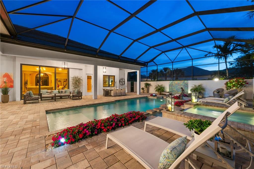 6363 Burnham Road Naples, FL 34119 - Photo 38 of 38 a view of a patio with table and chairs under an umbrella