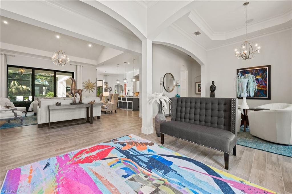 6363 Burnham Road Naples, FL 34119 - Photo 5 of 38 a living room with furniture and a rug