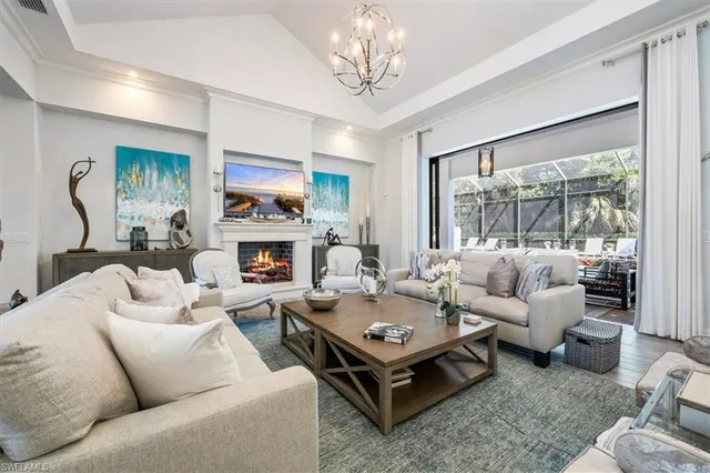 a living room with furniture fireplace and a large window