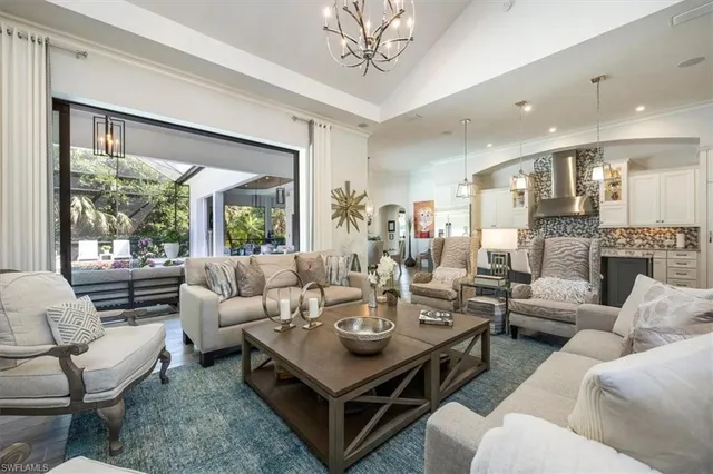 a living room with furniture a large window and a table